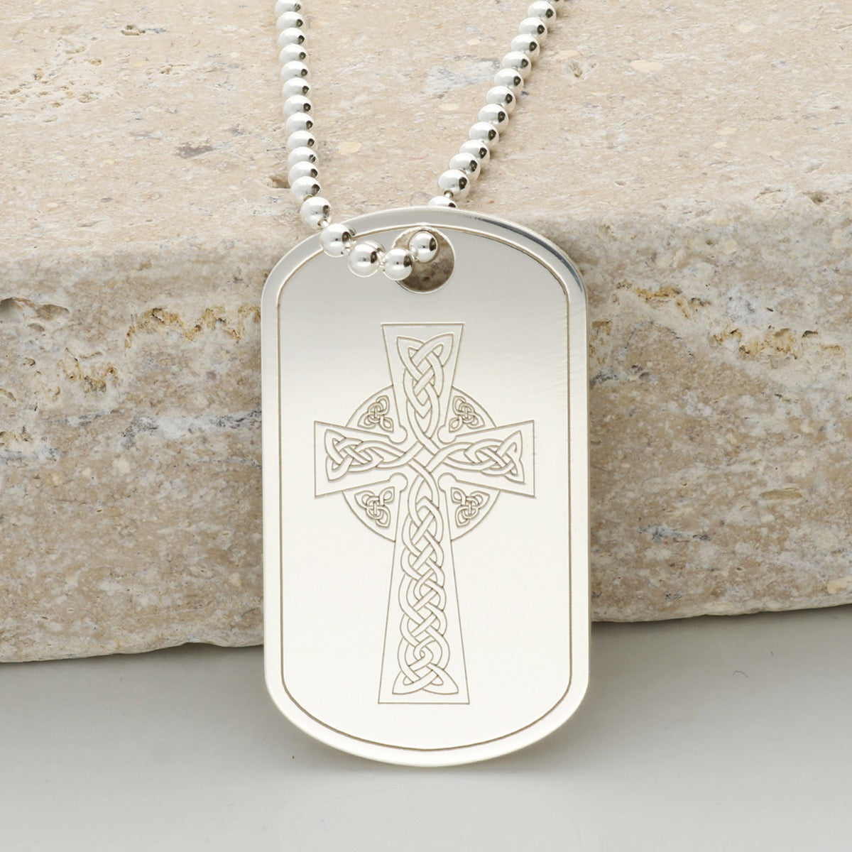sterling silver dog tag with an engraved Celtic cross design to the front and on a silver bead ball chain